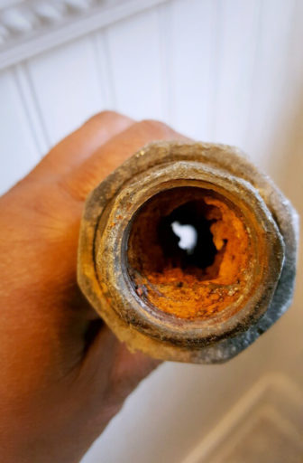 State Rep. LaTonya Johnson, D-Milwaukee, holds corroded galvanized plumbing that was removed from her Milwaukee house. Galvanized pipes, likely to be in older homes, can accumulate lead from service lines, such as the one supplying Johnson's home. Johnson operated a home day care for several years before running for public office. Photo courtesy of LaTonya Johnson.