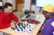 Davontae Franklin (right), a junior at Washington High School, plays against his head coach, Micheal Moore, in a friendly game of chess. Photo by Dean Bibens.