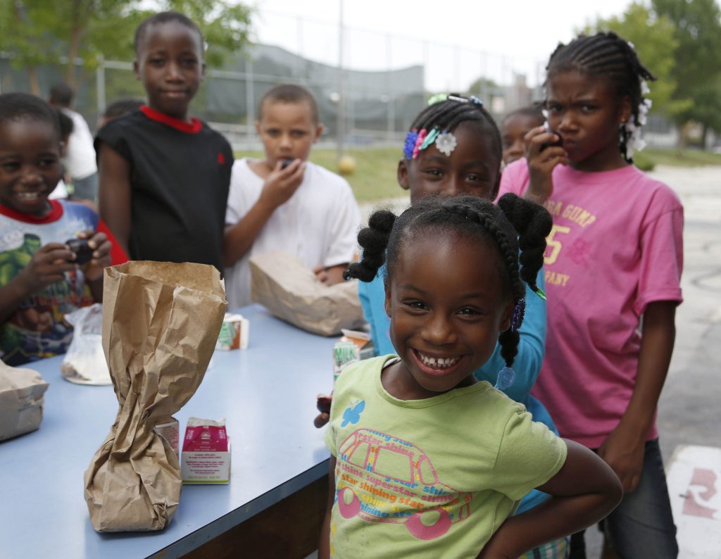 Kids enjoy a free meal program provided by the Milwaukee Summer Food Service program. Photo courtesy of Hunger Task Force.