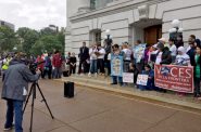 Immigrant dairy workers and their supporters, including Manuel and Jennifer Estrada, gather at the state Capitol in Madison, Wis. on June 28, 2017 to protest ramped up immigration enforcement policies under President Donald Trump and an anti-sanctuary proposal in the state Legislature. The rally was sponsored by the Milwaukee-based group, Voces de la Frontera. Photo by Alexandra Hall of WPR/Wisconsin Center for Investigative Journalism.