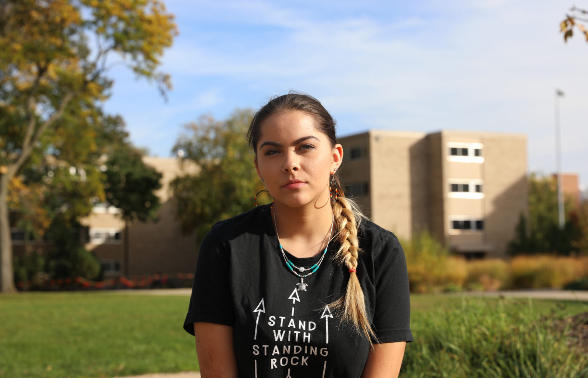 Mariah Skenandore is a co-president of Wunk Sheek, a Native American student group at the University of Wisconsin-Madison. She is a member of the Oneida and Bad River tribes. She poses here at a sacred fire circle near Dejope Residence Hall on the UW-Madison campus, where on Oct. 9 — Indigenous Peoples' Day — graffiti that read “Columbus Rules 1492” was written in red paint. Photo by Riley Vetterkind/Wisconsin Center for Investigative Journalism.