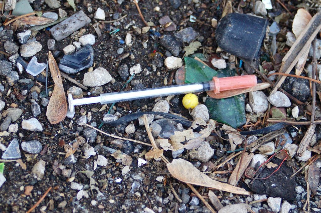 A discarded needle in an alley on the 2300 block of West Orchard Street on Milwaukee’s South Side. Photo by Edgar Mendez.