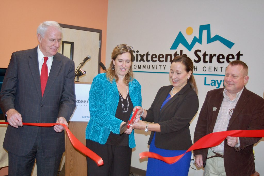 Dr. Julie Schuller (center left), Sixteenth Street CEO, and Cristy Garcia-Thomas, Aurora Health Care chief external affairs officer, mark the ceremonial opening of the Layton Clinic, as Mayor Tom Barrett (left); and state Rep. Josh Zepnick (right) look on. Photo by Andrea Waxman.