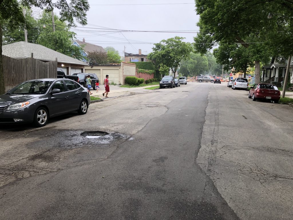 A large pothole on S. 25th St. just south of W. Greenfield Ave. Photo by Jeramey Jannene.