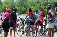 BGDB co-Leader Tonieh Welland (center) prepares a bike before the ride. Photo by Mary Bolich.