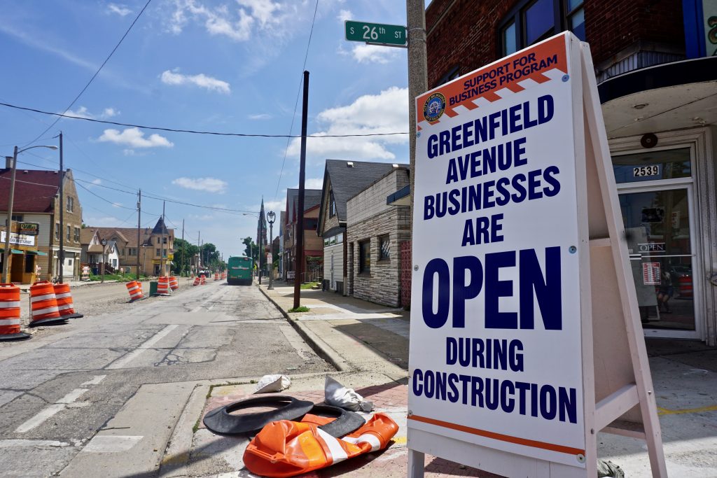 The Department of Public Works has placed signs in the construction zone offering detours to businesses because the entire westbound side of the road is closed. The eastbound lanes will be closed later this year. Photo by Abby Ng.