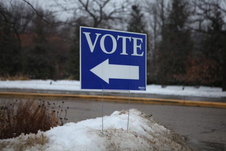 Wisconsin’s 2011 redistricting is under challenge in a U.S. Supreme Court case, which the plaintiffs argue discriminates against Democratic voters to create a persistent Republican majority in the Legislature. Here, a voting sign is seen outside the polling place at Olbrich Gardens on Feb. 20, 2018, in Madison. Photo by Coburn Dukehart / Wisconsin Center for Investigative Journalism.