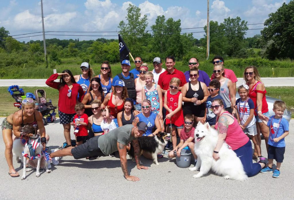 Walker poses with well-wishers before a parade in Franklin on Wednesday. Photo by Chuck Quirmbach/WPR.