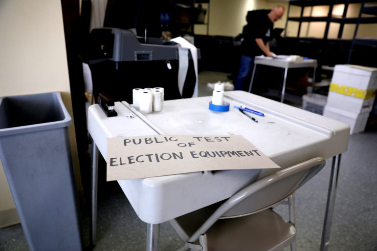 A public test of election equipment was conducted in Madison, Wis., ahead of the Aug. 14, 2018 primary. A group of paid staff and volunteers test all the voting machines by running ballots with all voting scenarios for that ballot, and for each candidate, through the machines and making sure they tally them correctly. Photo by Coburn Dukehart / Wisconsin Center for Investigative Journalism.