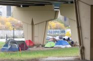 Tent camps are set up by homeless people under the highway at 6th street between Michigan and St. Paul streets. Photo courtesy of NNS.