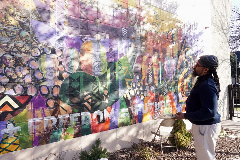 Brad Bernard admires the near-finished mural. Photo by Sarah Lipo/NNS.