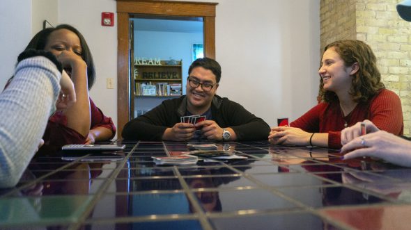Annie Clark, Volunteer/Intern (on the right) playing UNO with Jennifer Bowman, Therapist (on the left), and DJ Ferrer, Intern Therapist (in the center). Photo by Ryan Mueller.