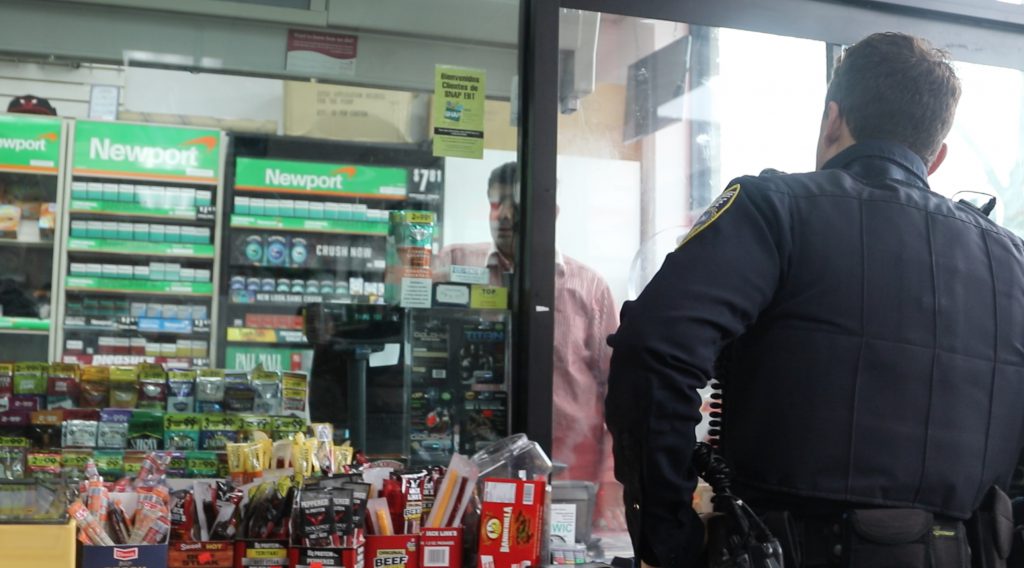 MPD Officer Matthew Diener stops at a corner store in Clarke Square. Photo by Madison Marx/NNS.