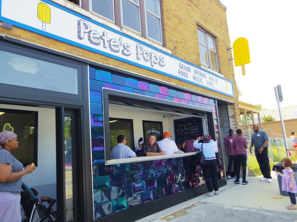 Community members gather for the grand opening of the new Pete’s Pops storefront on the Near West Side. Owner Pete Cooney had been selling his popsicles for three summers when he heard about the inaugural Rev-Up Milwaukee small business competition. Photo by Robyn Di Giacinto/NNS.