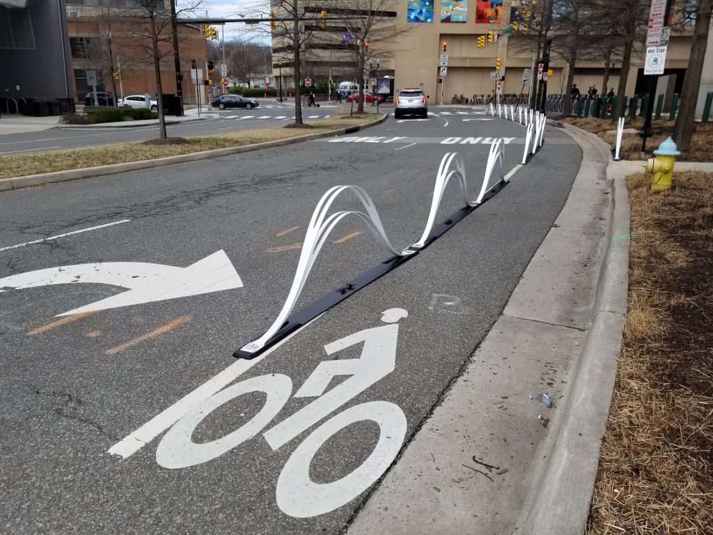 “Wave Delineator” bikeway barriers on Potomac Avenue in Crystal City. <a href="https://www.flickr.com/photos/beyonddc/47350321631/" target="_blank">Image</a> by BeyondDC licensed under <a href="https://creativecommons.org/licenses/by-nc/2.0/" target="_blank">Creative Commons</a>.