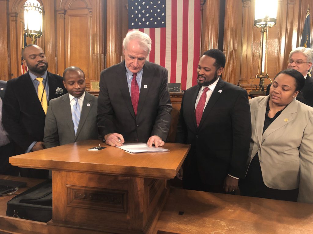 Mayor Barrett signs the resolution approving the deal with the DNC. Photo by Jeramey Jannene.