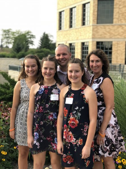 Bailey and Lily Dove, their mother Erin Dove, and father and West Bend director Ryan Dove at the company’s fundraising event for the MACC Fund. Photo courtesy of West Bend Mutual Insurance Company.