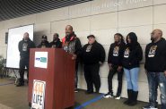 Chris Conley, speaking at the podium, is one of 10 violence interrupters for Milwaukee's new 414Life program. Photo by Corrinne Hess/WPR.
