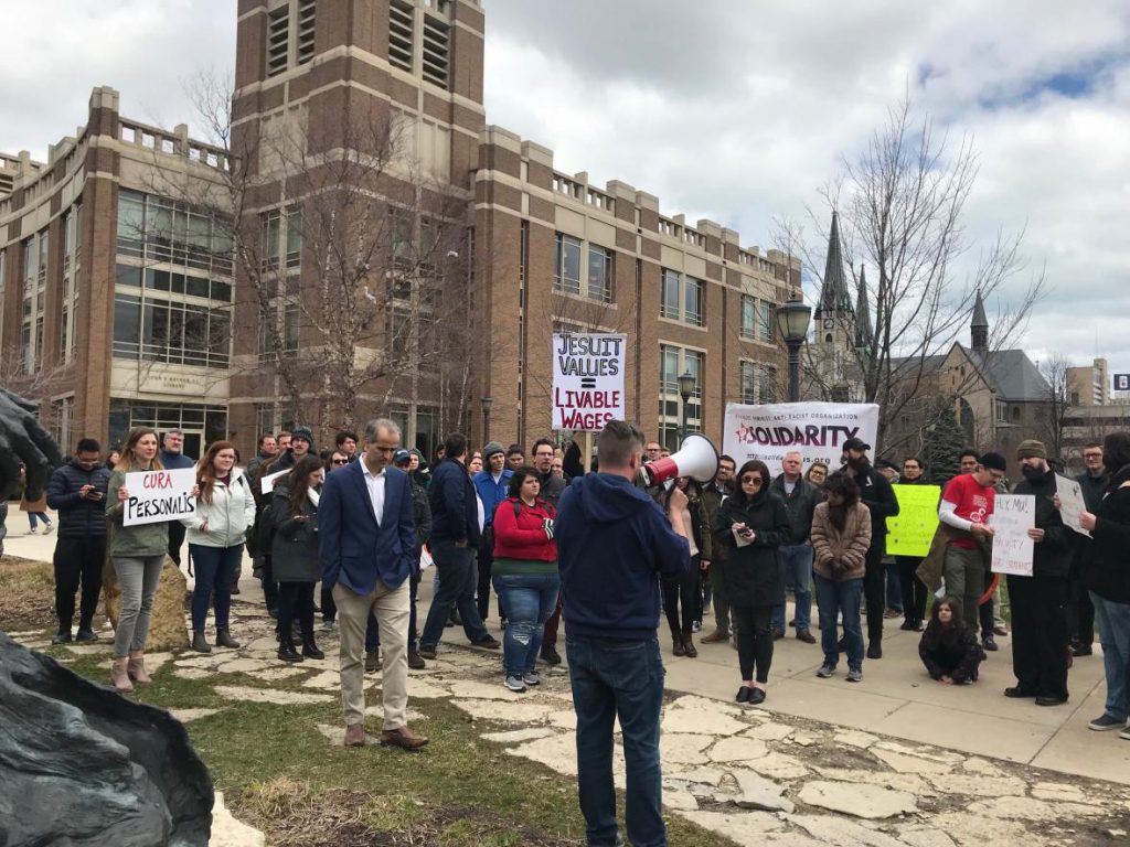 Marquette University faculty and graduate students held a rally Friday, April 12, in front of the Marquette University Raynor Memorial Libraries, asking university administration for a fair process to form a union. Photo by Corrinne Hess/WPR.