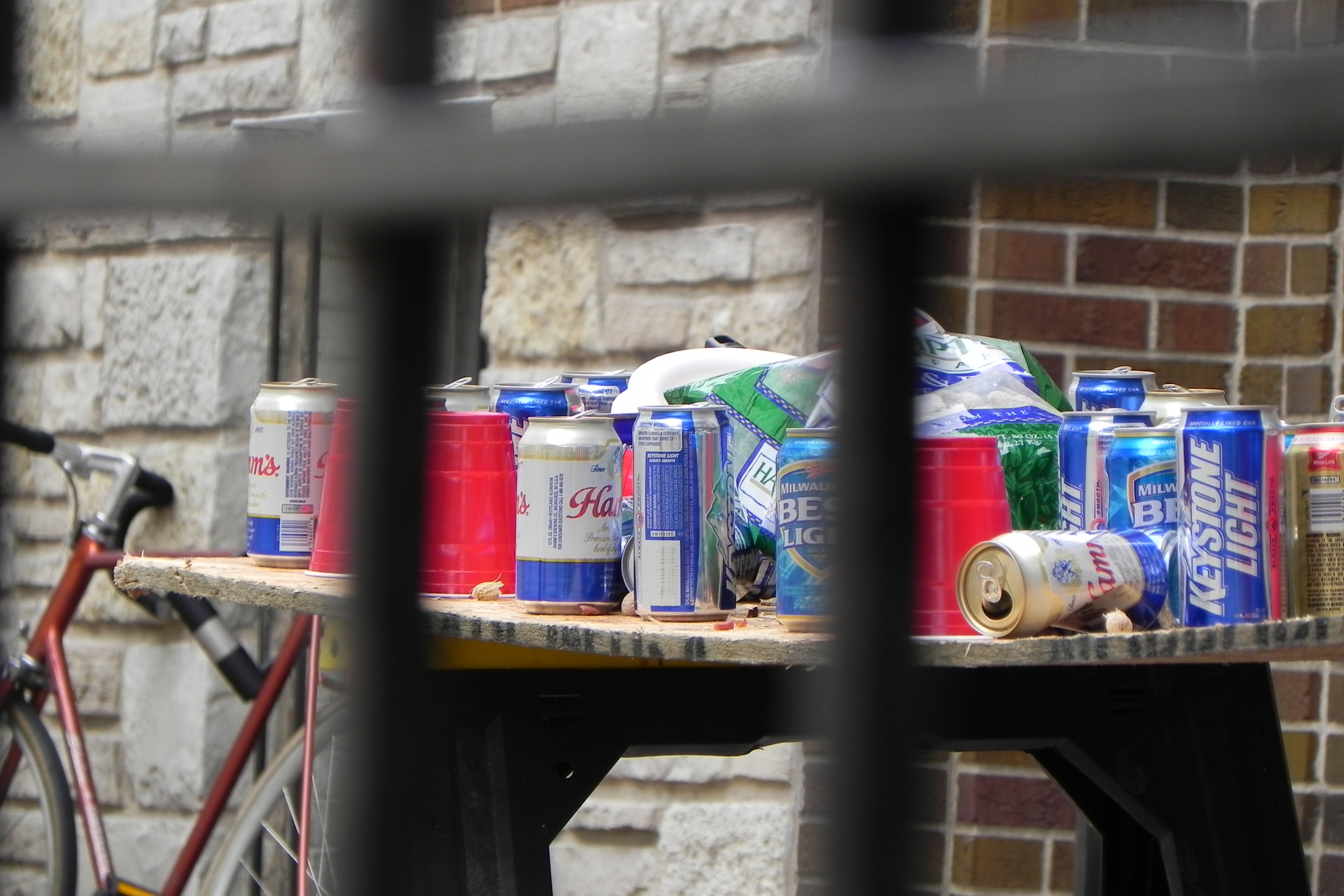 Empty beer cans cover a makeshift table in Madison on a football Saturday in 2010. Photo by Richard Hurd (CC BY 2.0)