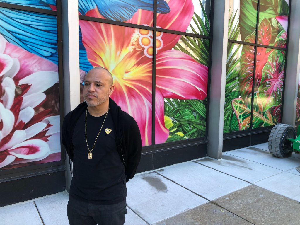 Artist Carlos Rolón poses in front of Gild the Lilly at the Chase Tower. Photo by Jeramey Jannene.