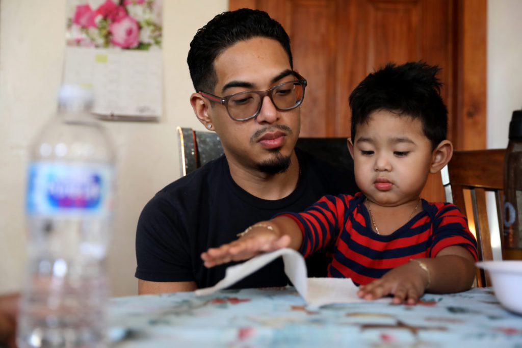 Erick Gamboa holds his son Adriel, 2, while the family has an afternoon snack in their Milwaukee home on Feb. 8, 2019. Gamboa, an undocumented immigrant from Mexico, was recently detained in the Kenosha County Detention Center for six months for illegally crossing the border in 2010, but a judge ruled he can stay in the United States. Unlike most immigrants, Gamboa had a lawyer to argue his case. Statistics show immigrants have a much lower chance of deportation if they have a lawyer. Photo by Coburn Dukehart/Wisconsin Center for Investigative Journalism.