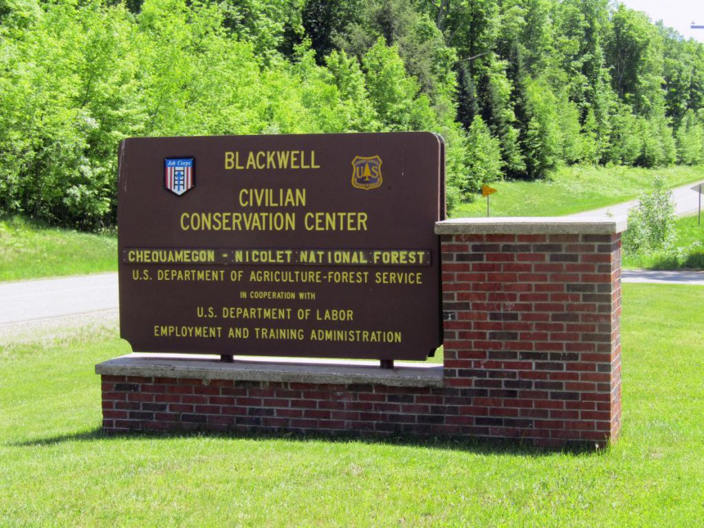 A sign outside the job center site identifies Blackwell Job Corps Center as part of a program shared by the U.S. Forest Service and the Department of Labor. Photo by Rob Mentzer/WPR.