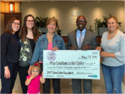 Cullen Run Board Chair Gael Garbarino Cullen (center) and her daughters (from left to right) Colleen, Molly, and Annie, and her granddaughter present a $41,285 check to Dr. Ivor Benjamin, director of the Cardiovascular Center at MCW.