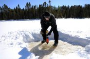 Jeff Rubsam uses a power auger to drill a hole in the ice of Little Rock Lake in Vilas County, Wis., on March 12, 2019. He is a research assistant for the state Department of Natural Resources and University of Wisconsin-Madison’s Center for Limnology working with scientist Carl Watras to measure the levels of mercury in the lake over time. Photo by Sarah Whites-Koditschek/WPR.