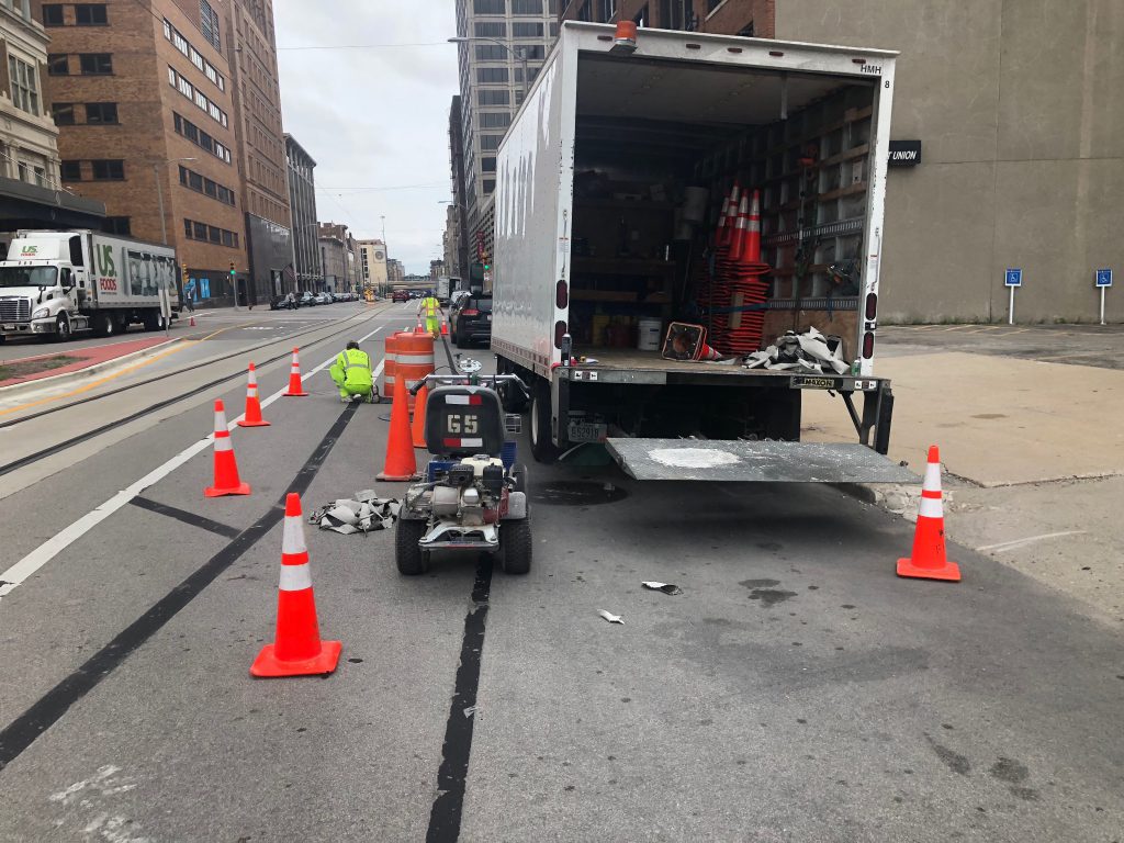 The Broadway buffered bike lane is removed on August 7th, 2018. Photo by Jeramey Jannene.
