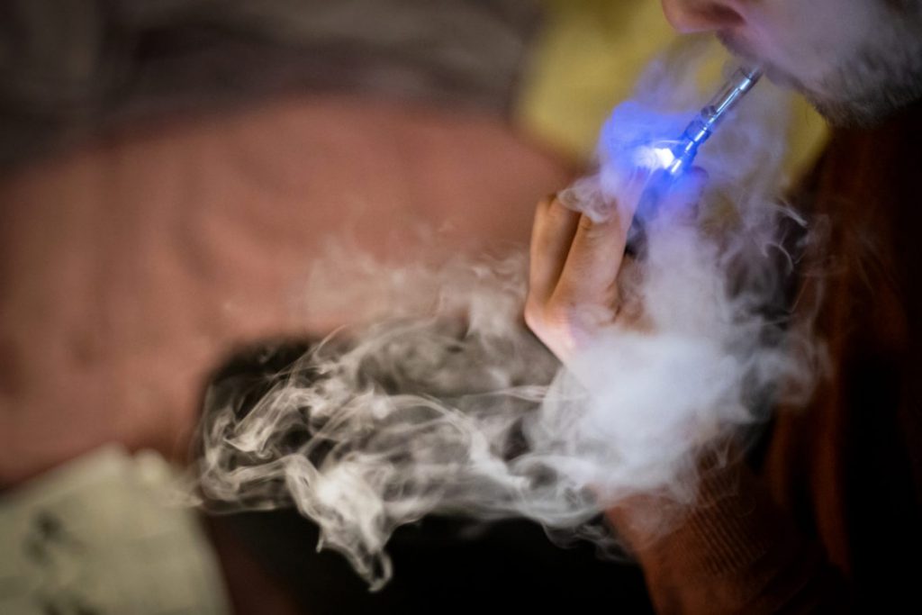 Marijuana is currently classified as a Schedule I drug by the U.S. Drug Enforcement Administration, defined as a substance with “no currently accepted medical use and a high potential for abuse.” Here, a 24-year-old Madison resident takes a drag from a cannabis vape cartridge on March 31, 2019. In 2018, blacks were four times as likely to be arrested for marijuana possession in Wisconsin as whites, statistics show. Photo by Emily Hamer/Wisconsin Watch.