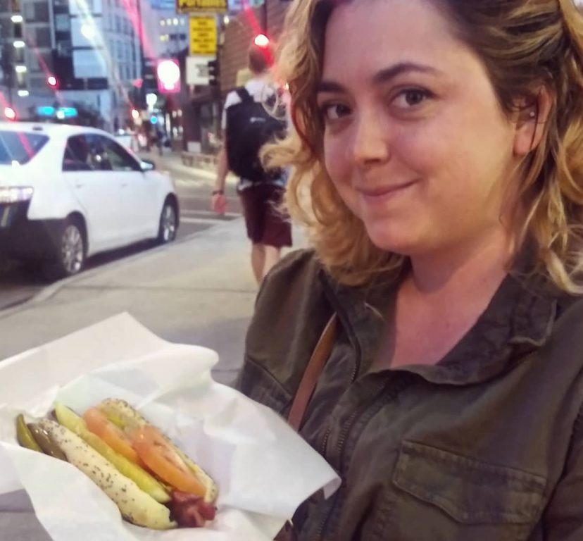 Madison Butler with a Chicago-style hot dog in the Windy City. Image from Rail Passengers Association.