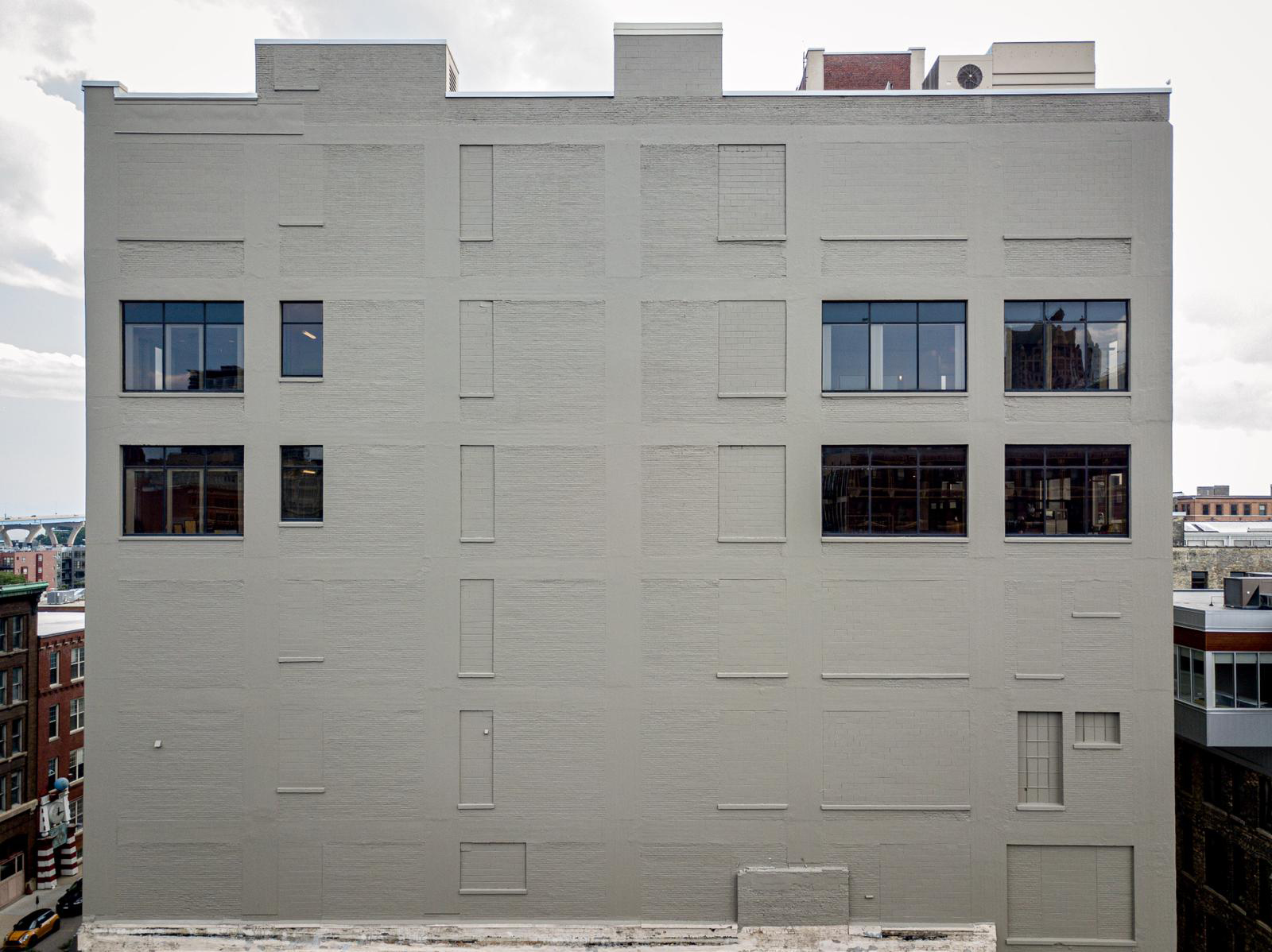 World-Renowned Muralist Painting High Rise in Milwaukee’s Historic Third Ward