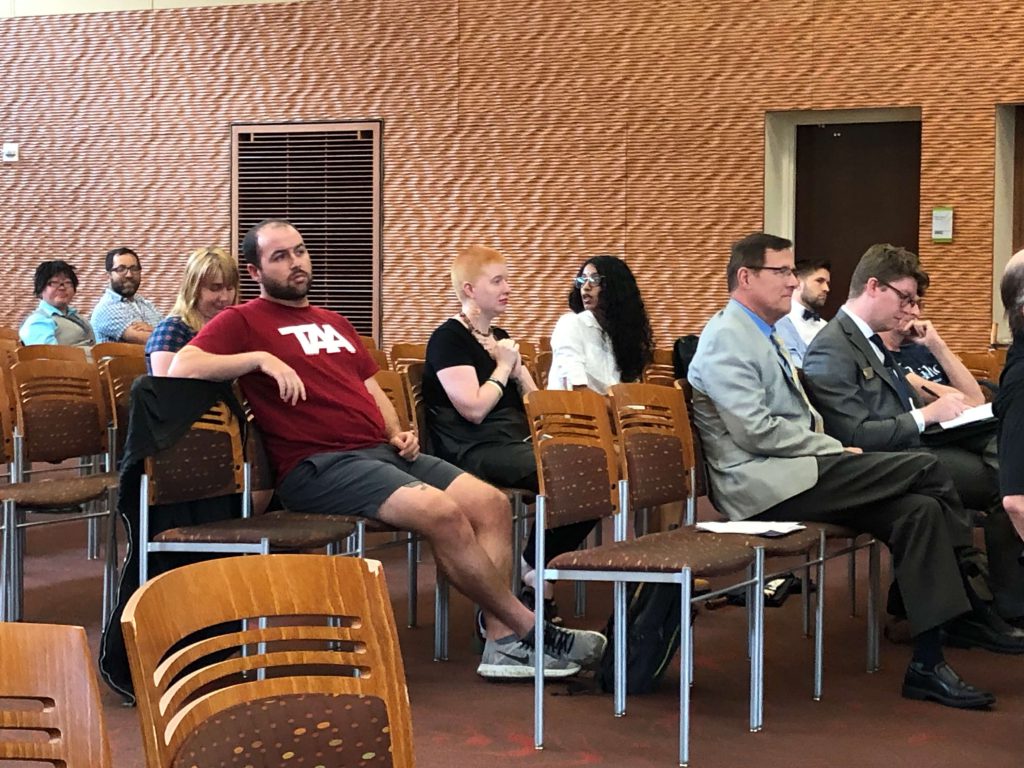 Speakers, including professors and graduate students, wait to address creating a rule that prescribes penalties up to expulsion for students who disrupt campus speakers. Photo courtesy of the Wisconsin Examiner.