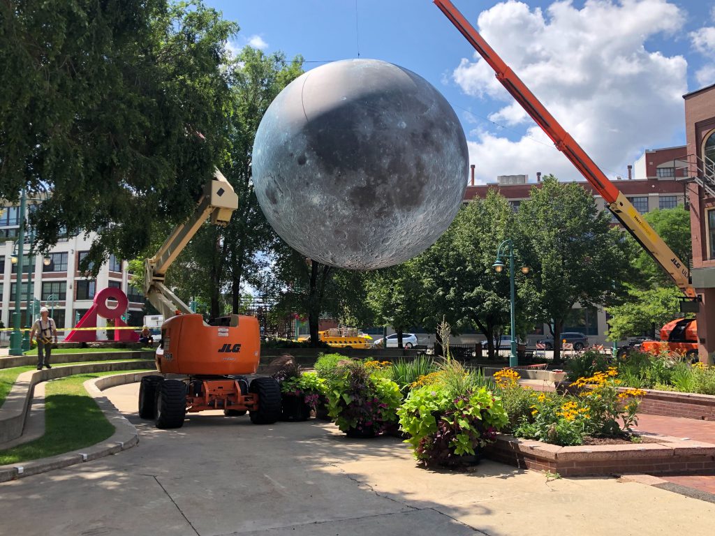 Preparing to raise a replica of the moon in Catalano Square. Photo by Jeramey Jannene.