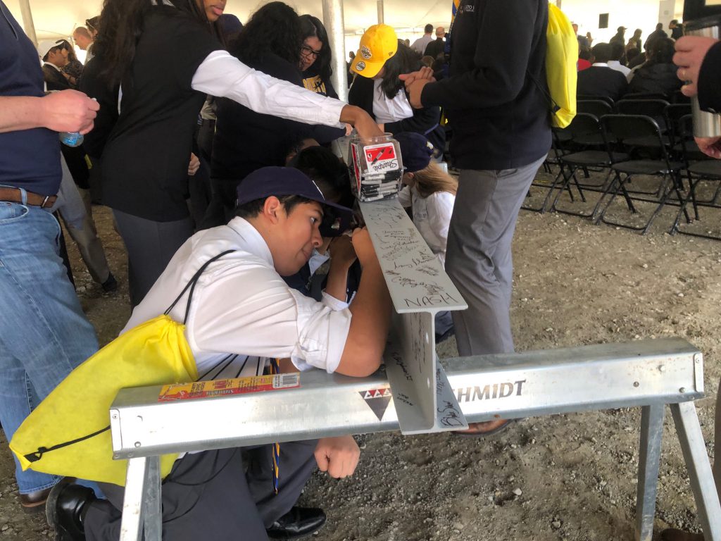 Cristo Rey students sign a steel beam to be used in the new school. Photo by Jeramey Jannene.