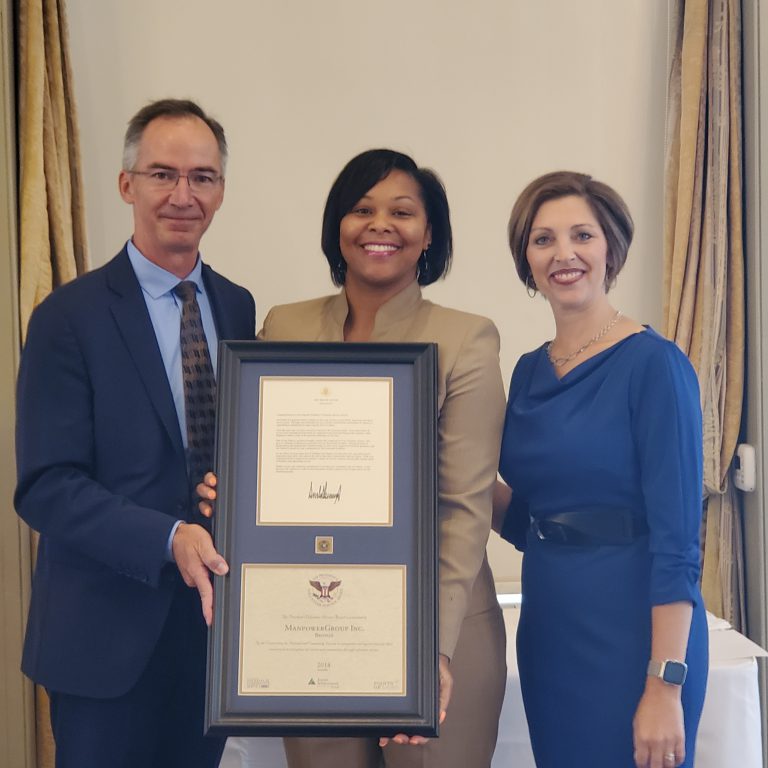 On behalf of Manpower Group, Nafessa Jackson, Community Investment Manager (center), accepts the 2017-2018 U.S. President's Volunteer Service Award from Junior Achievement of Wisconsin (JA) President, Michael Frohna (left), and JA of Wisconsin Board Chair, Kara Kaiser (right), at the JA Annual Meeting on September 25 in Milwaukee.