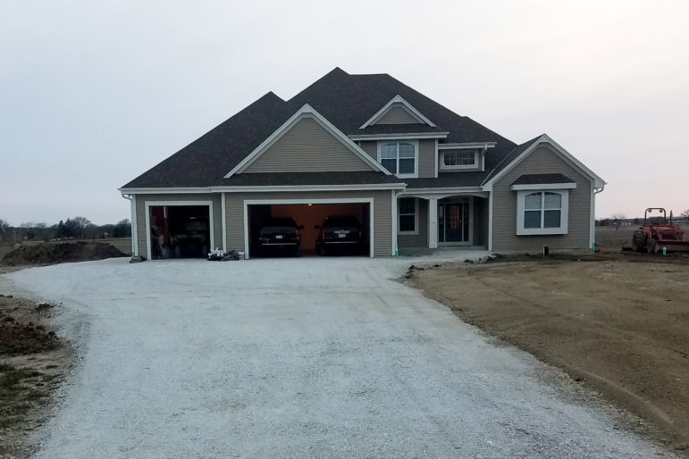 On May 15, 2017, Shawn and Sarah Mayer of Mount Pleasant, Wis., and their two young children moved into a custom built, 3,800-square-foot home. One month later, they found out Foxconn was coming. “When it was announced, I had just had 36 pallets of paving bricks delivered,” Mayer says. The couple sold the new home and 8 acres of land to the village to make way for the project. Photo courtesy of Shawn Mayer.