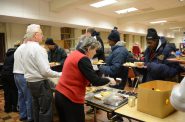 Volunteers serve a meal to guests at St. Benedict the Moor, 924 W. State St., which provides walk-in and 2-1-1 referrals for shelter in extreme cold weather. File photo by Sue Vliet/NNS.