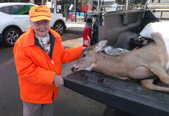 Florence Teeters stands with her first buck on her first hunt at age 104. Photo by Bill Ball/Wisconsin DNR.