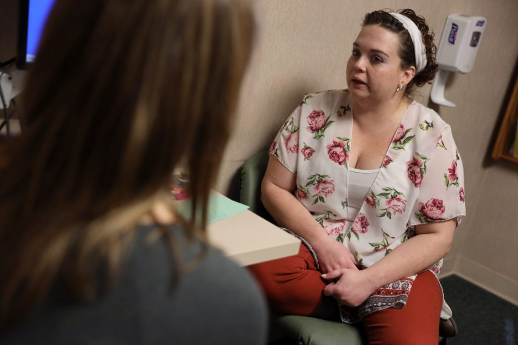 Dr. Angela Gatzke-Plamann is seen at the Necedah Family Medical Center in Necedah, Wis., on November 7, doing a check-in with Catina Stoflet, 35, who has been on medication-assisted treatment for seven months. “I probably would have died of a heroin overdose if I didn’t do this program,” says Stoflet. “It’s changed my life. My goal is that in a year I’ll be down in dosage. Enough is enough.” Photo by Coburn Dukehart/Wisconsin Watch.