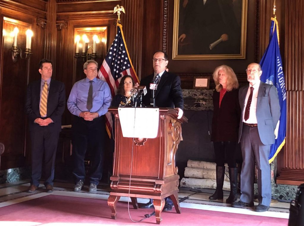 Plaintiffs who filed a lawsuit against the vaguely worded Marsy's Law constitutional amendment to try to keep it off the April 2020 ballot. Speaking at a Dec. 19, 2019 press conference, on the left: Craig Johnson, Matt Rothschild, Jerome Buting (speaking). On the right: Jacqueline Boynton and Dennis Grzezinski. Photo by Melanie Conklin/Wisconsin Examiner.
