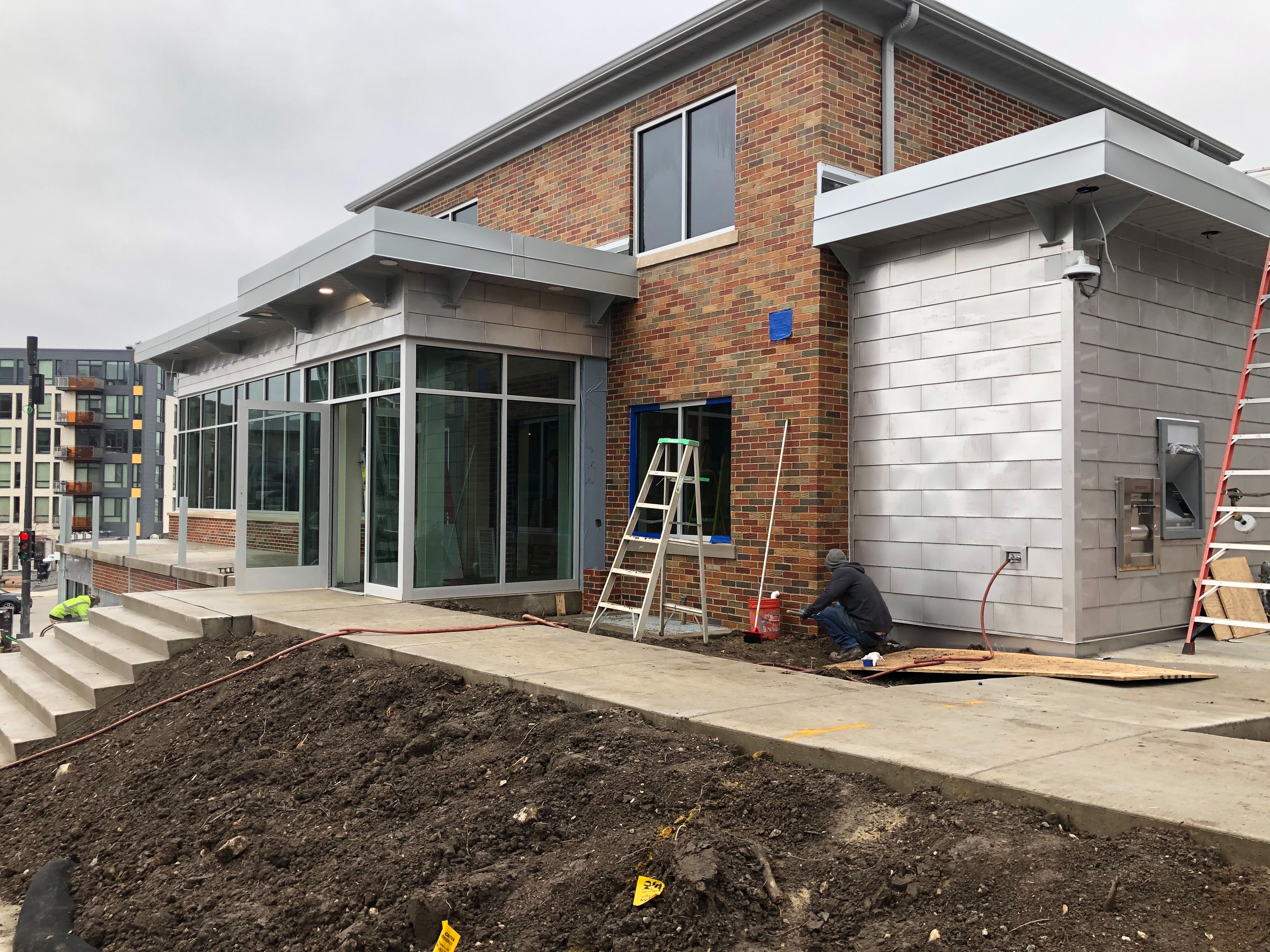 Image of North Shore Bank North End Bank illustrating existing brick house and new stainless steel and aluminum additions