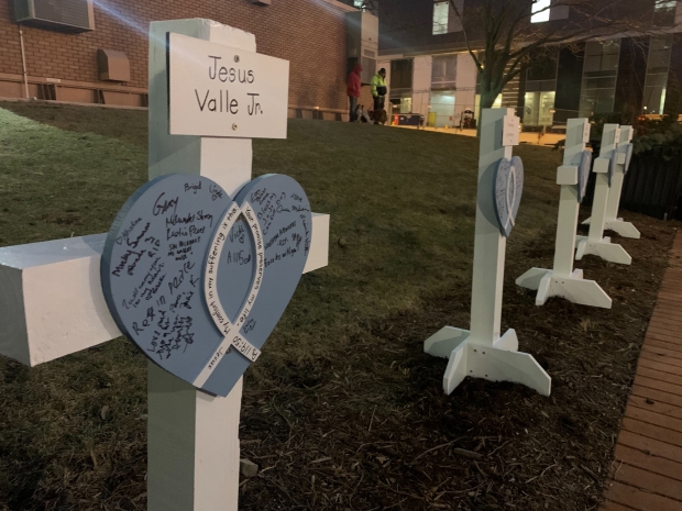 Lutheran Church Charities provided signs for vigil goers to write comforting messages on. The organization will send the signs to the victims families. Photo by Alana Watson/WPR.