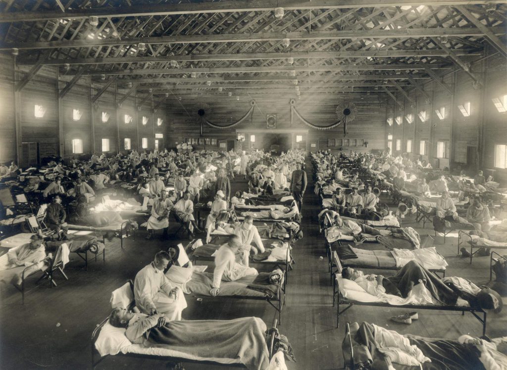 Influenza patients fill beds in an emergency hospital located at Camp Funston, a U.S. Army training camp in Kansas, during the 1918-19 influenza pandemic. National Museum of Health and Medicine (pubilc domain).