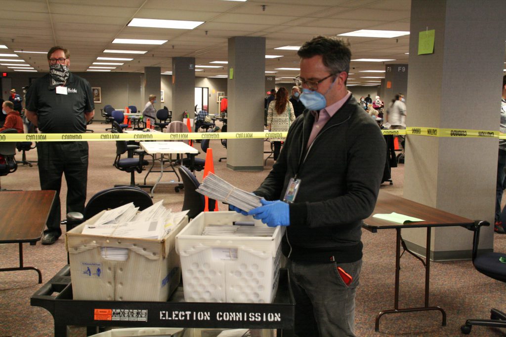 Milwaukee Election Commission Executive Director Neil Albrecht looks through absentee ballots. Photo by Jeramey Jannene.