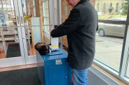 Jeramey Jannene deposits his absentee ballot in a City of Milwaukee drop box. Photo by Alison Peterson.