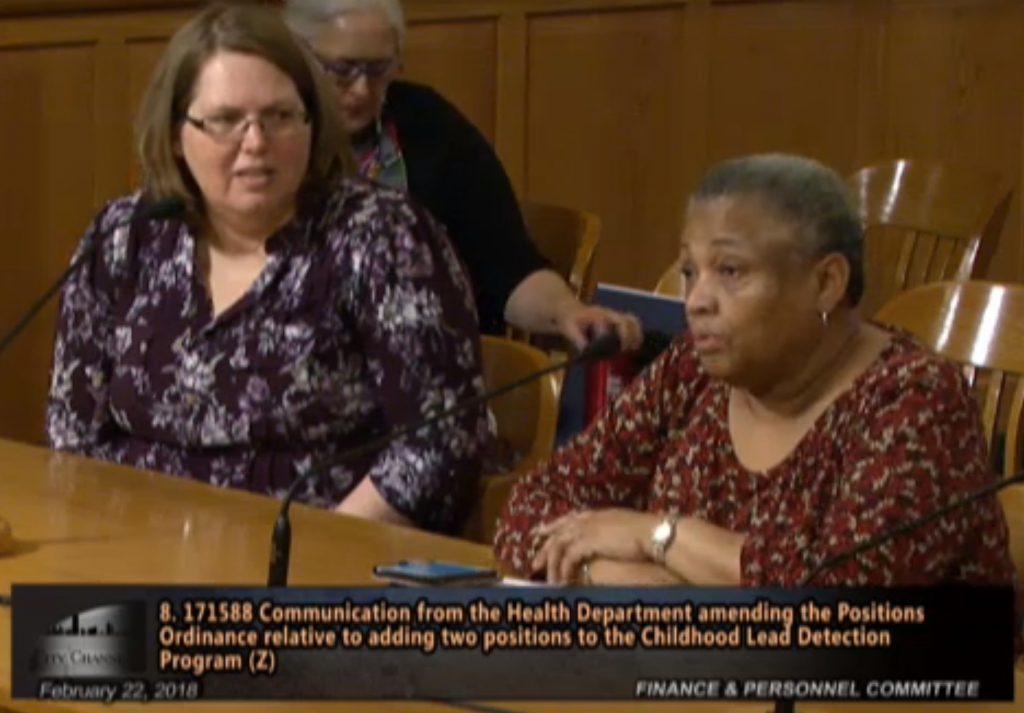 Angela Hagy looks on as Patricia McManus addresses a council committee in February 2018. Image from City of Milwaukee City Channel.