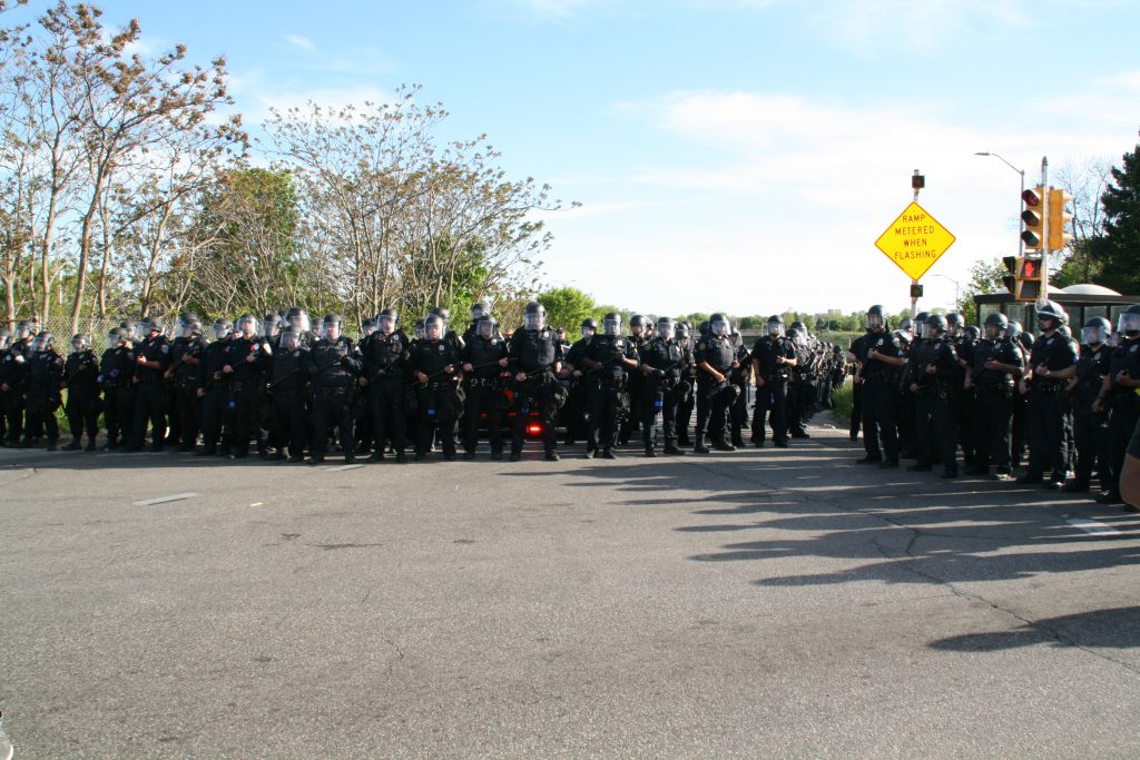 Milwaukee Police Department officers block a freeway on-ramp from protesters. Photo by Jeramey Jannene.