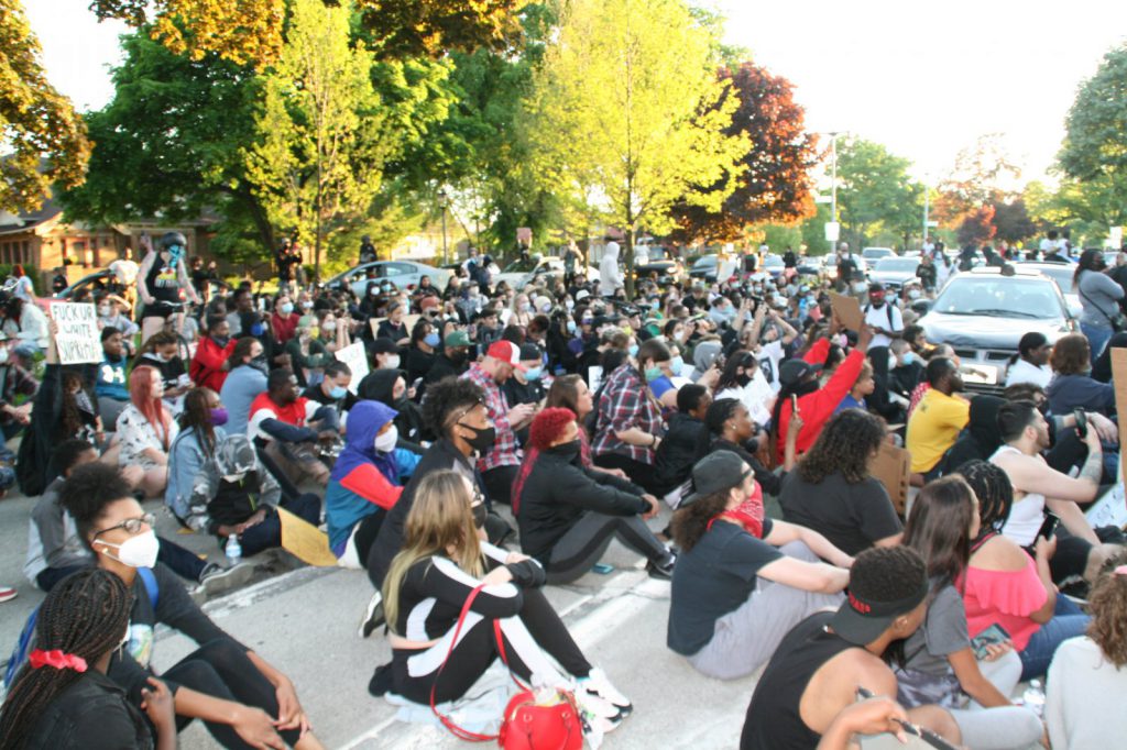 On May 30th, protesters sat in the street in front of Mayor Barrett's home listening to speeches. Photo by Jeramey Jannene.